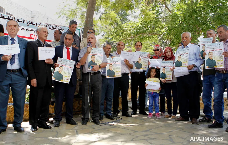 Palestinians take part in a demonstration calling for the release of Bilal Kayed a Palestinian prisoner on hunger strike, in the West bank city of Hebron on July 12, 2016. Photo by Wisam Hashlamoun