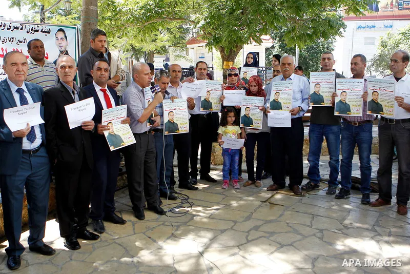 Palestinians take part in a demonstration calling for the release of Bilal Kayed a Palestinian prisoner on hunger strike, in the West bank city of Hebron on July 12, 2016. Photo by Wisam Hashlamoun