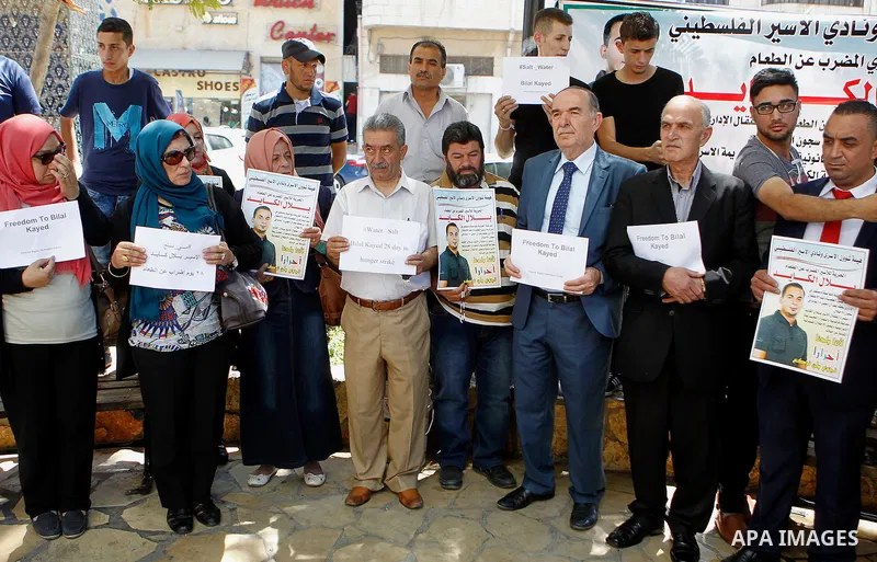 Palestinians take part in a demonstration calling for the release of Bilal Kayed a Palestinian prisoner on hunger strike, in the West bank city of Hebron on July 12, 2016. Photo by Wisam Hashlamoun