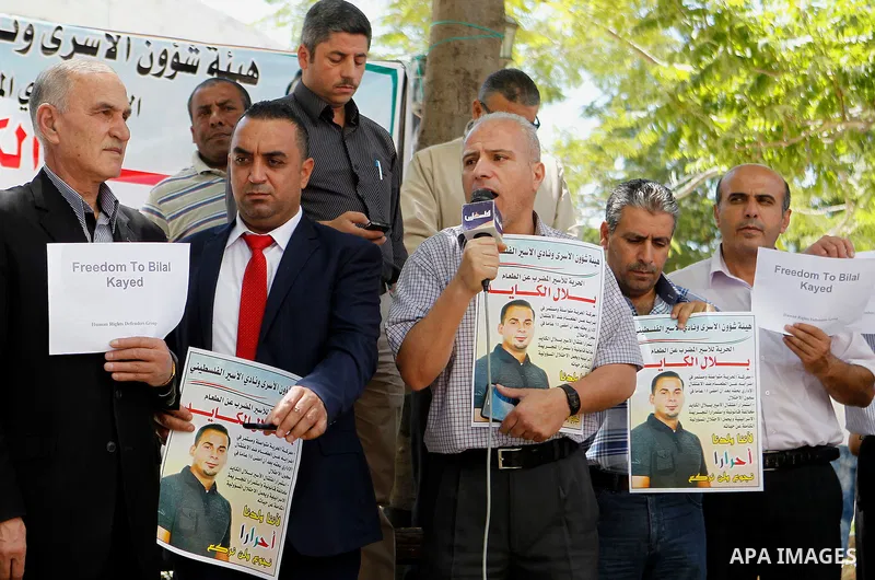 Palestinians take part in a demonstration calling for the release of Bilal Kayed a Palestinian prisoner on hunger strike, in the West bank city of Hebron on July 12, 2016. Photo by Wisam Hashlamoun