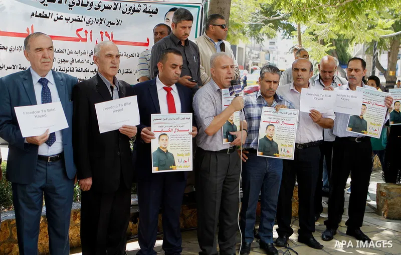 Palestinians take part in a demonstration calling for the release of Bilal Kayed a Palestinian prisoner on hunger strike, in the West bank city of Hebron on July 12, 2016. Photo by Wisam Hashlamoun