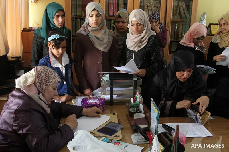 Palestinian high school students look for their results of final high school exams, known as "Tawjihi" in Rafah in the southern Gaza strip on July 12, 2016. Photo by Abed Rahim Khatib