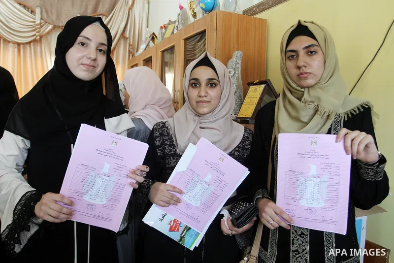 Palestinian high school students celebrate after heard their results of final exams known as "Tawjihi" in Rafah in the southern Gaza strip on July 12, 2016. Photo by Abed Rahim Khatib