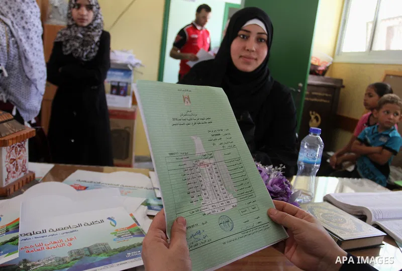 Palestinian high school students look for their results of final high school exams, known as "Tawjihi" in Rafah in the southern Gaza strip on July 12, 2016. Photo by Abed Rahim Khatib