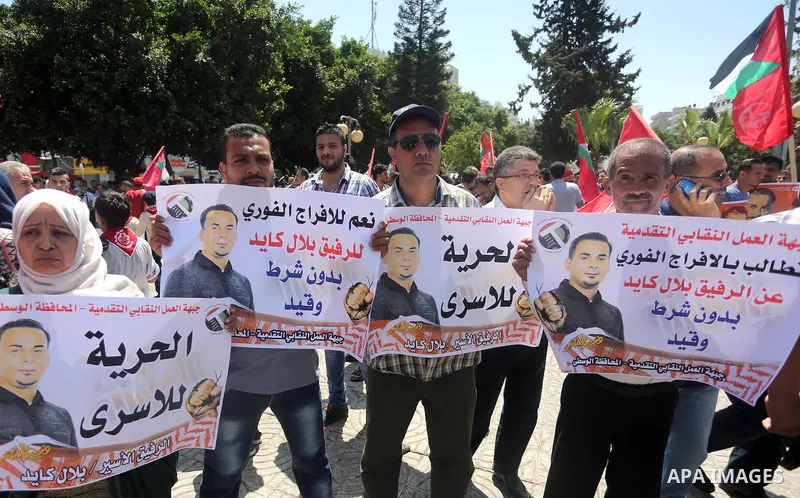 Supporters of the Popular Front for the Liberation of Palestine (PFLP) take part in a demonstration calling for the release of Bilal Kayed a Palestinian prisoner on hunger strike, in Gaza city on July 13, 2016. Photo by...
