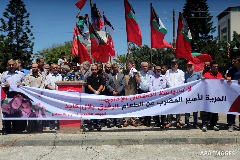 Supporters of the Popular Front for the Liberation of Palestine (PFLP) take part in a demonstration calling for the release of Bilal Kayed a Palestinian prisoner on hunger strike, in Gaza city on July 13, 2016. Photo by...
