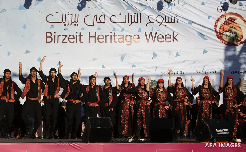Palestinian youths dance during a wedding in Heritage week in the village of Bir Zeit, in the West Bank near Ramallah, on July 13, 2016. Photo by Shadi Hatem