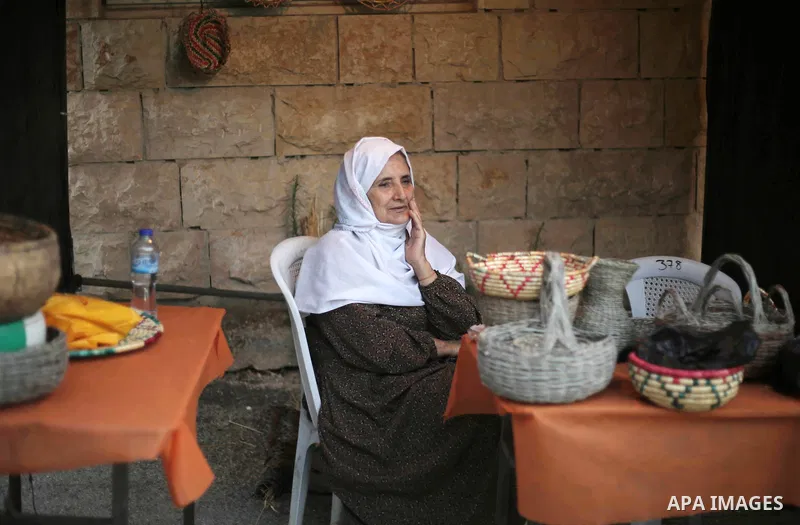 A Palestinian woman participates during Heritage week in the village of Bir Zeit, in the West Bank near Ramallah, on July 13, 2016. Photo by Shadi Hatem