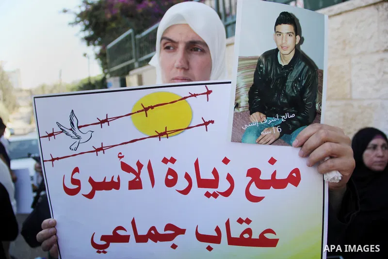 Relatives of Palestinian prisoners in Israeli jails take part in a protest against the decision of Israeli authorities minimize visits the Palestinian prisoners in front of Red cross office, in Jerusalem, on July 13, 201...