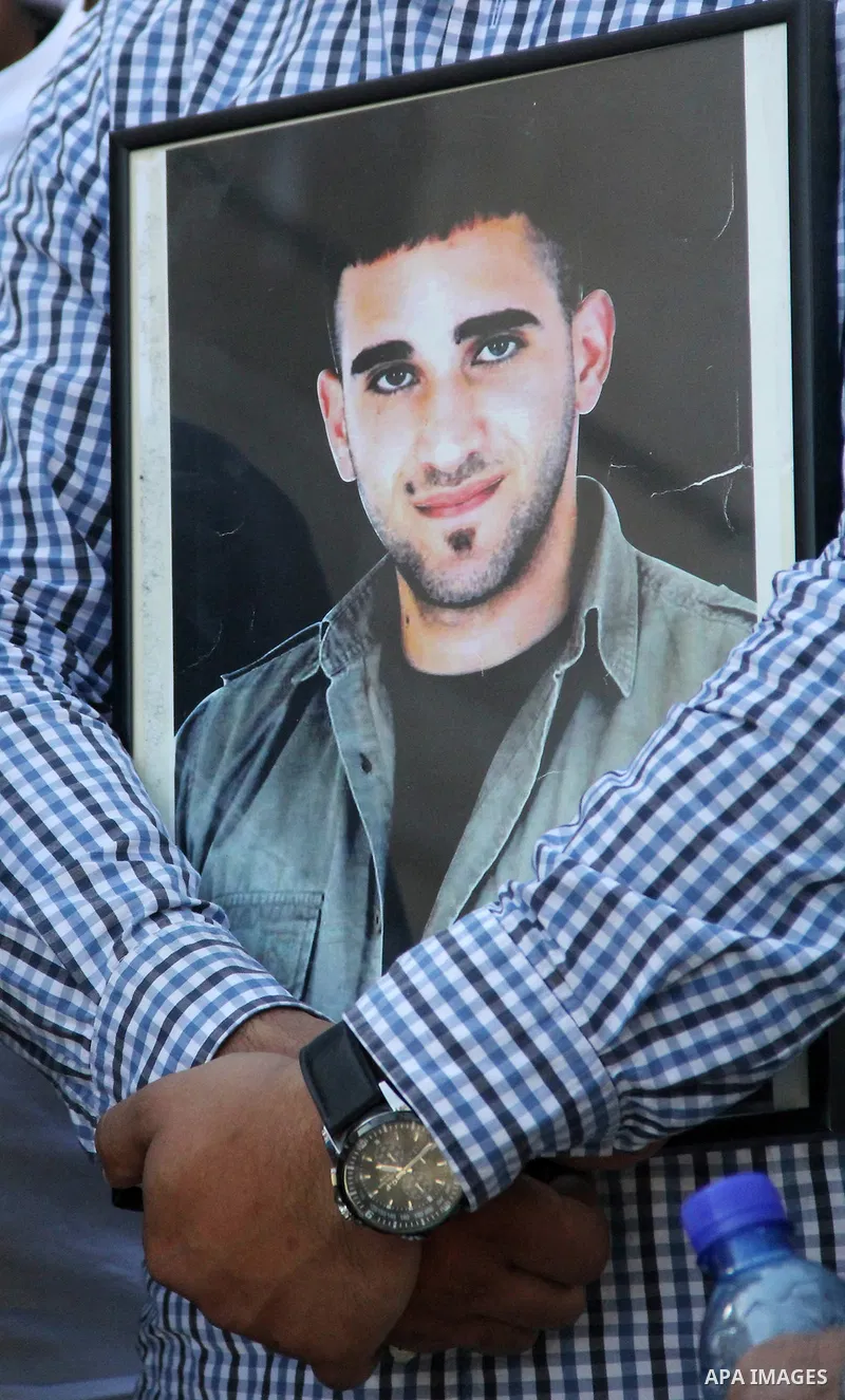 Relatives of Palestinian prisoners in Israeli jails take part in a protest against the decision of Israeli authorities minimize visits the Palestinian prisoners in front of Red cross office, in Jerusalem, on July 13, 201...