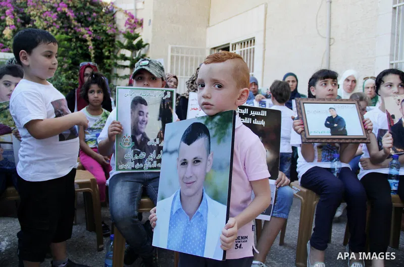 Relatives of Palestinian prisoners in Israeli jails take part in a protest against the decision of Israeli authorities minimize visits the Palestinian prisoners in front of Red cross office, in Jerusalem, on July 13, 201...