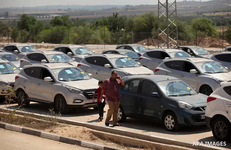 Palestinian men inspect vehicles that came from Israel to serve the Gaza Strip market on July 14, 2016 in the Palestinian side of the Erez crossing with Israel. Israel opened the major Erez crossing point between Israel...