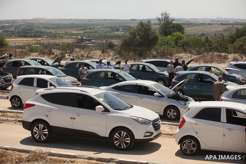 Palestinian men inspect vehicles that came from Israel to serve the Gaza Strip market on July 14, 2016 in the Palestinian side of the Erez crossing with Israel. Israel opened the major Erez crossing point between Israel...