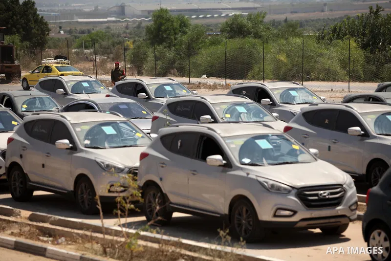 A Palestinian man inspects vehicles that came from Israel to serve the Gaza Strip market on July 14, 2016 in the Palestinian side of the Erez crossing with Israel. Israel opened the major Erez crossing point between Isra...