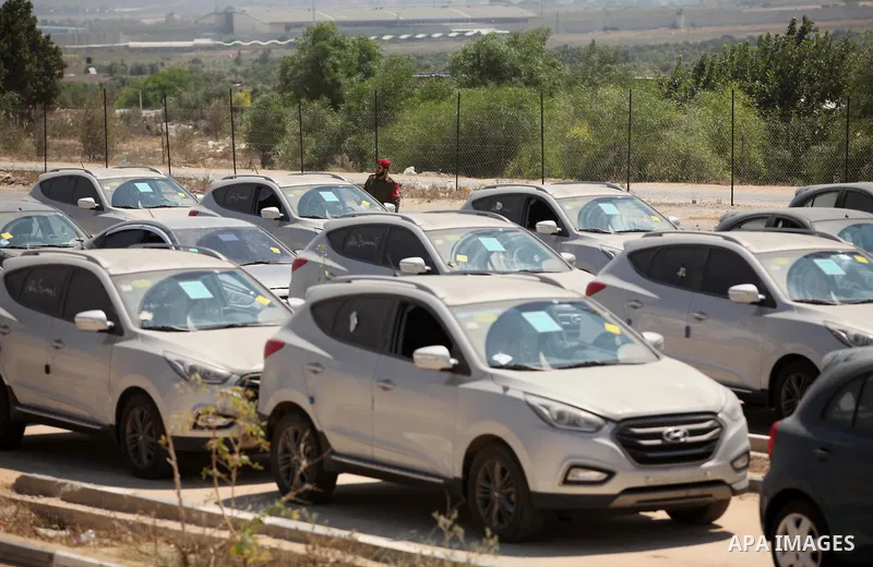 A Palestinian man inspects vehicles that came from Israel to serve the Gaza Strip market on July 14, 2016 in the Palestinian side of the Erez crossing with Israel. Israel opened the major Erez crossing point between Isra...
