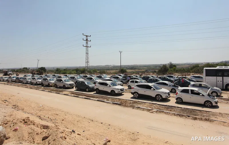 A Palestinian man inspects vehicles that came from Israel to serve the Gaza Strip market on July 14, 2016 in the Palestinian side of the Erez crossing with Israel. Israel opened the major Erez crossing point between Isra...