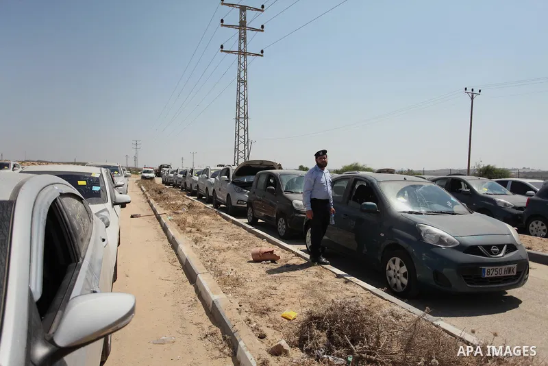 A Palestinian man inspects vehicles that came from Israel to serve the Gaza Strip market on July 14, 2016 in the Palestinian side of the Erez crossing with Israel. Israel opened the major Erez crossing point between Isra...