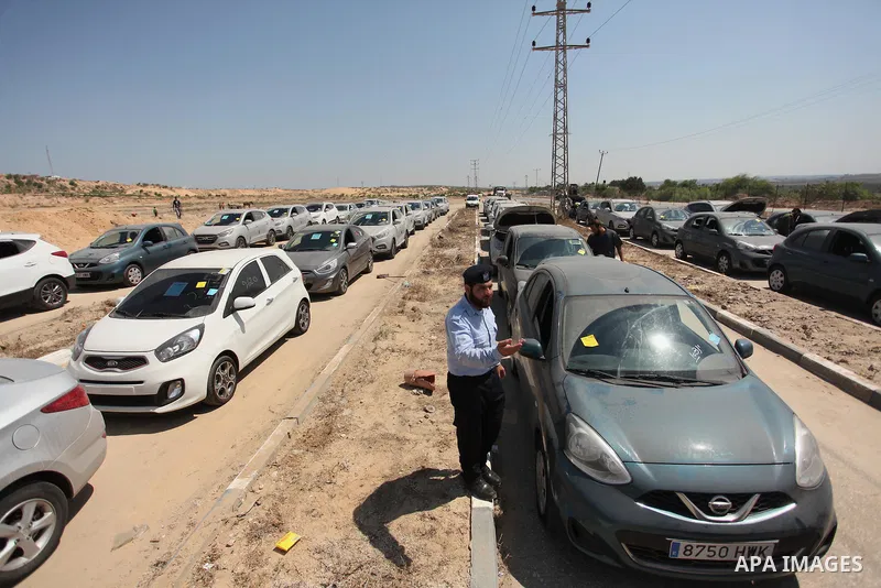 A Palestinian man inspects vehicles that came from Israel to serve the Gaza Strip market on July 14, 2016 in the Palestinian side of the Erez crossing with Israel. Israel opened the major Erez crossing point between Isra...
