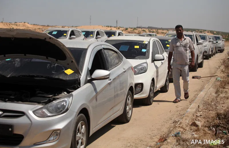 A Palestinian man inspects vehicles that came from Israel to serve the Gaza Strip market on July 14, 2016 in the Palestinian side of the Erez crossing with Israel. Israel opened the major Erez crossing point between Isra...