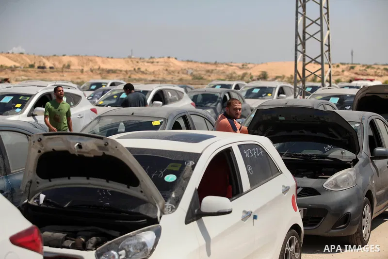 Palestinian men inspect vehicles that came from Israel to serve the Gaza Strip market on July 14, 2016 in the Palestinian side of the Erez crossing with Israel. Israel opened the major Erez crossing point between Israel...