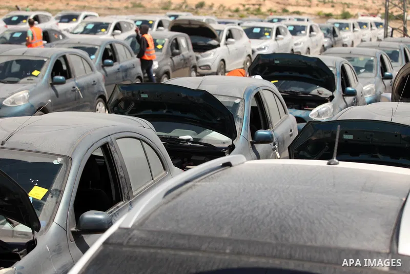 Palestinian men inspect vehicles that came from Israel to serve the Gaza Strip market on July 14, 2016 in the Palestinian side of the Erez crossing with Israel. Israel opened the major Erez crossing point between Israel...