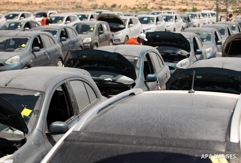 Palestinian men inspect vehicles that came from Israel to serve the Gaza Strip market on July 14, 2016 in the Palestinian side of the Erez crossing with Israel. Israel opened the major Erez crossing point between Israel...