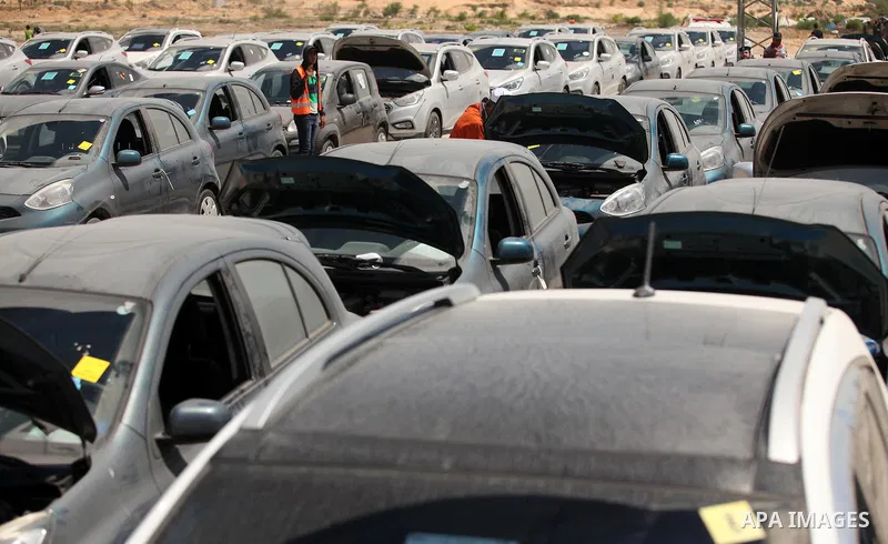 Palestinian men inspect vehicles that came from Israel to serve the Gaza Strip market on July 14, 2016 in the Palestinian side of the Erez crossing with Israel. Israel opened the major Erez crossing point between Israel...