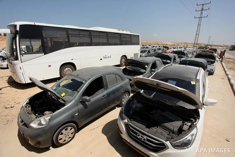 A Palestinian man inspects vehicles that came from Israel to serve the Gaza Strip market on July 14, 2016 in the Palestinian side of the Erez crossing with Israel. Israel opened the major Erez crossing point between Isra...