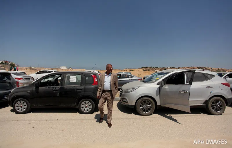 A Palestinian man inspects vehicles that came from Israel to serve the Gaza Strip market on July 14, 2016 in the Palestinian side of the Erez crossing with Israel. Israel opened the major Erez crossing point between Isra...