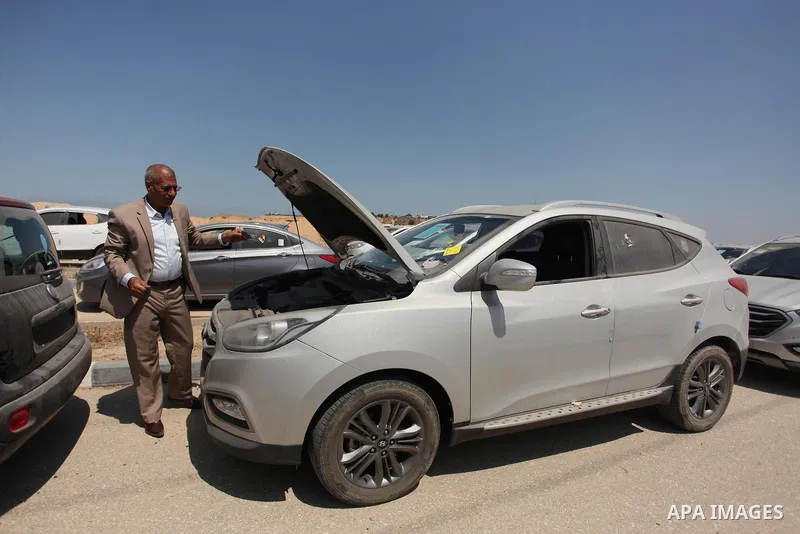 A Palestinian man inspects vehicles that came from Israel to serve the Gaza Strip market on July 14, 2016 in the Palestinian side of the Erez crossing with Israel. Israel opened the major Erez crossing point between Isra...