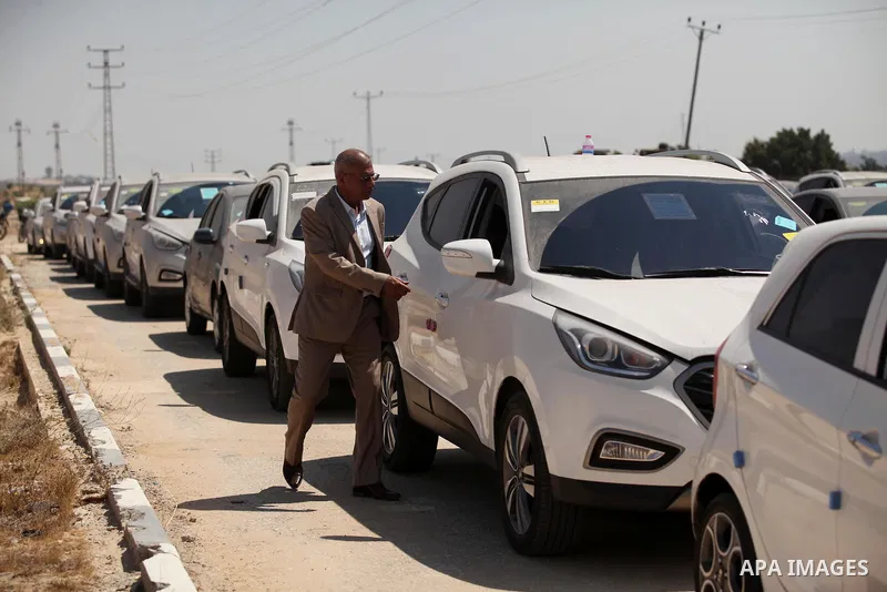 A Palestinian man inspects vehicles that came from Israel to serve the Gaza Strip market on July 14, 2016 in the Palestinian side of the Erez crossing with Israel. Israel opened the major Erez crossing point between Isra...