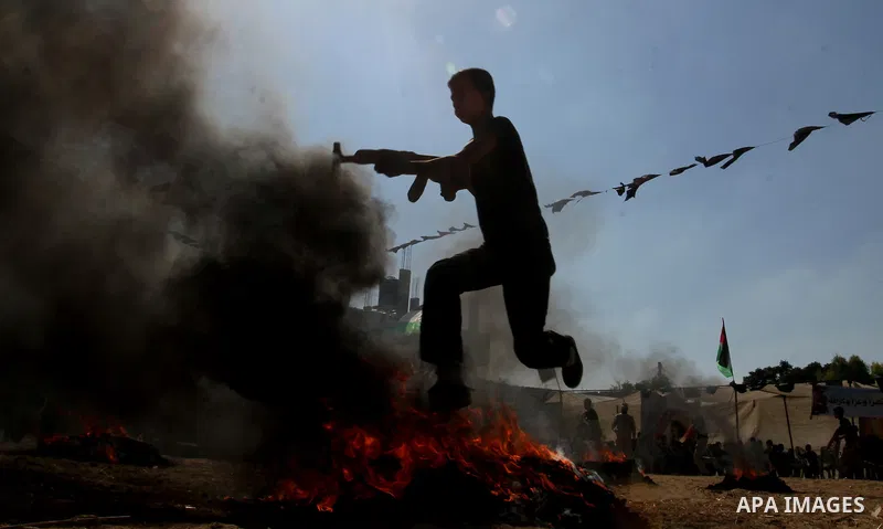 Young Palestinians take part in a military-style exercise at a summer camp organised by the Islamic Jihad movement in Khan Yunis in the southern Gaza Strip, during the youngsters' summer school vacation, on July 14, 2016...