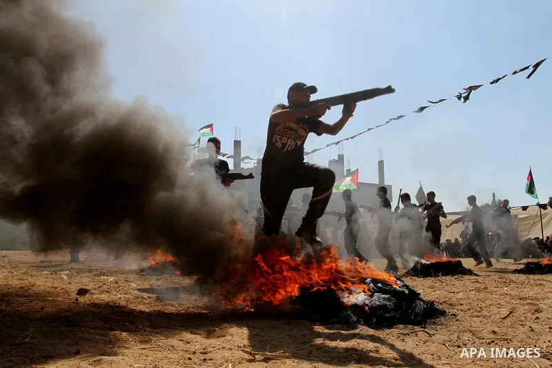 Young Palestinians take part in a military-style exercise at a summer camp organised by the Islamic Jihad movement in Khan Yunis in the southern Gaza Strip, during the youngsters' summer school vacation, on July 14, 2016...