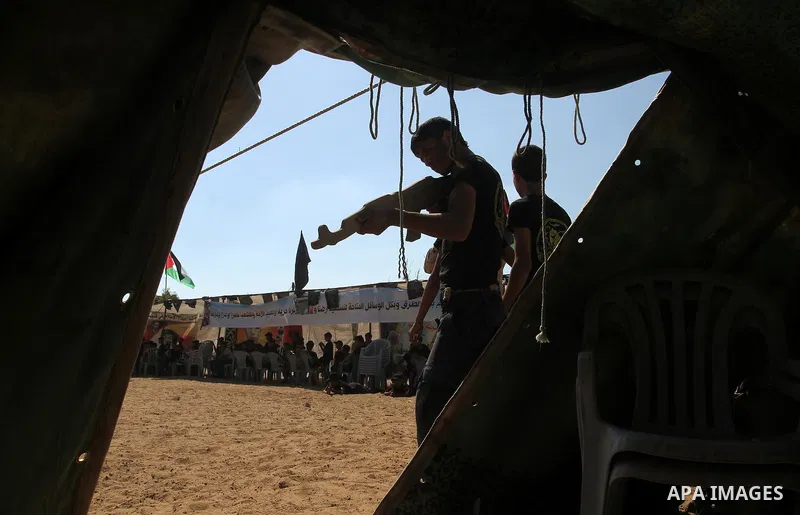 Young Palestinians take part in a military-style exercise at a summer camp organised by the Islamic Jihad movement in Khan Yunis in the southern Gaza Strip, during the youngsters' summer school vacation, on July 14, 2016...