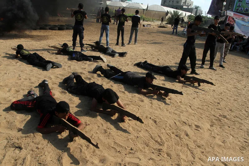 Young Palestinians take part in a military-style exercise at a summer camp organised by the Islamic Jihad movement in Khan Yunis in the southern Gaza Strip, during the youngsters' summer school vacation, on July 14, 2016...