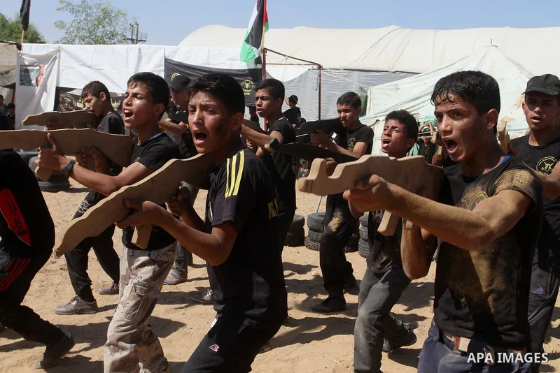Young Palestinians take part in a military-style exercise at a summer camp organised by the Islamic Jihad movement in Khan Yunis in the southern Gaza Strip, during the youngsters' summer school vacation, on July 14, 2016...