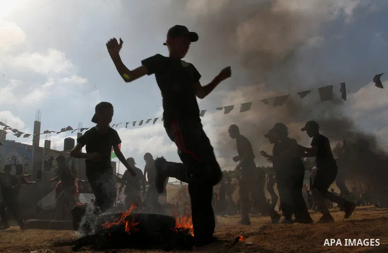 Young Palestinians take part in a military-style exercise at a summer camp organised by the Islamic Jihad movement in Khan Yunis in the southern Gaza Strip, during the youngsters' summer school vacation, on July 14, 2016...