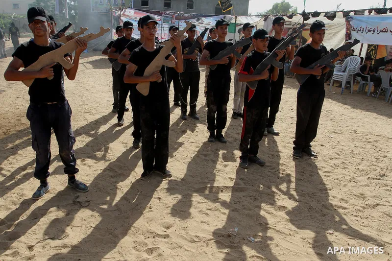 Young Palestinians take part in a military-style exercise at a summer camp organised by the Islamic Jihad movement in Khan Yunis in the southern Gaza Strip, during the youngsters' summer school vacation, on July 14, 2016...