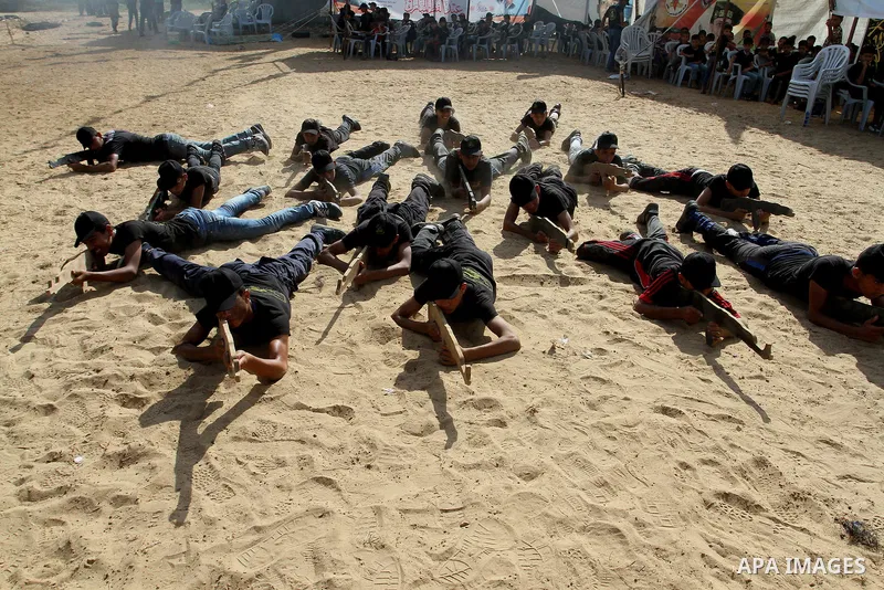 Young Palestinians take part in a military-style exercise at a summer camp organised by the Islamic Jihad movement in Khan Yunis in the southern Gaza Strip, during the youngsters' summer school vacation, on July 14, 2016...