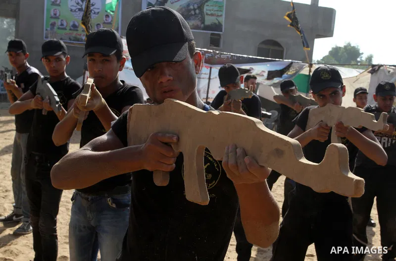 Young Palestinians take part in a military-style exercise at a summer camp organised by the Islamic Jihad movement in Khan Yunis in the southern Gaza Strip, during the youngsters' summer school vacation, on July 14, 2016...