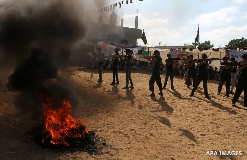Young Palestinians take part in a military-style exercise at a summer camp organised by the Islamic Jihad movement in Khan Yunis in the southern Gaza Strip, during the youngsters' summer school vacation, on July 14, 2016...