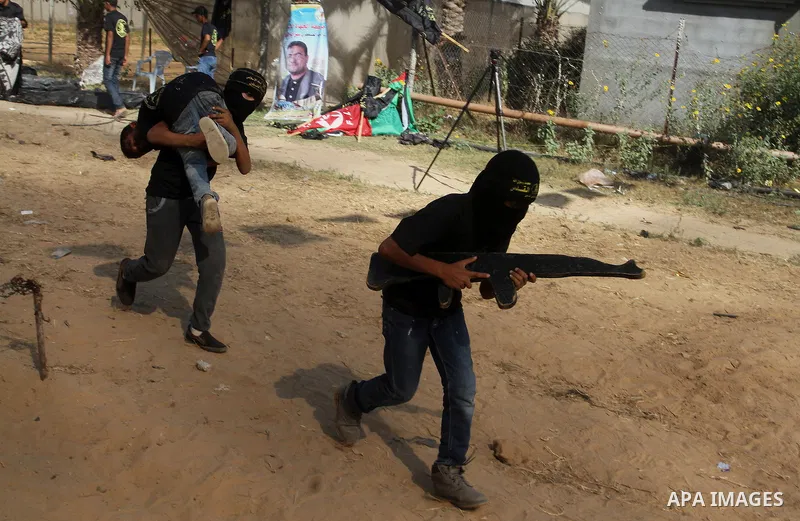 Young Palestinians take part in a military-style exercise at a summer camp organised by the Islamic Jihad movement in Khan Yunis in the southern Gaza Strip, during the youngsters' summer school vacation, on July 14, 2016...