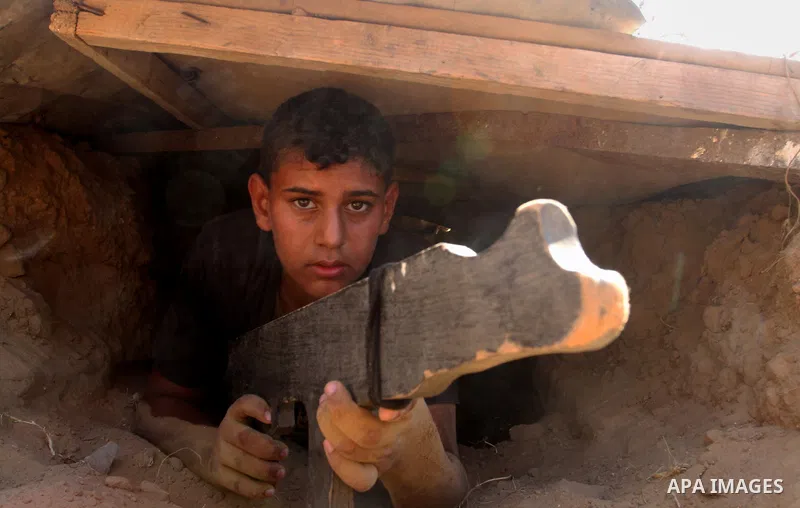 Young Palestinians take part in a military-style exercise at a summer camp organised by the Islamic Jihad movement in Khan Yunis in the southern Gaza Strip, during the youngsters' summer school vacation, on July 14, 2016...
