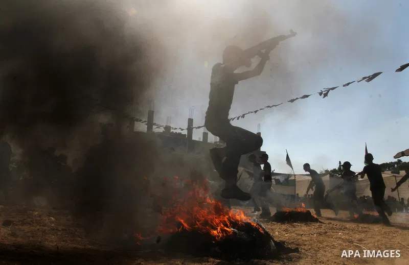 Young Palestinians take part in a military-style exercise at a summer camp organised by the Islamic Jihad movement in Khan Yunis in the southern Gaza Strip, during the youngsters' summer school vacation, on July 14, 2016...