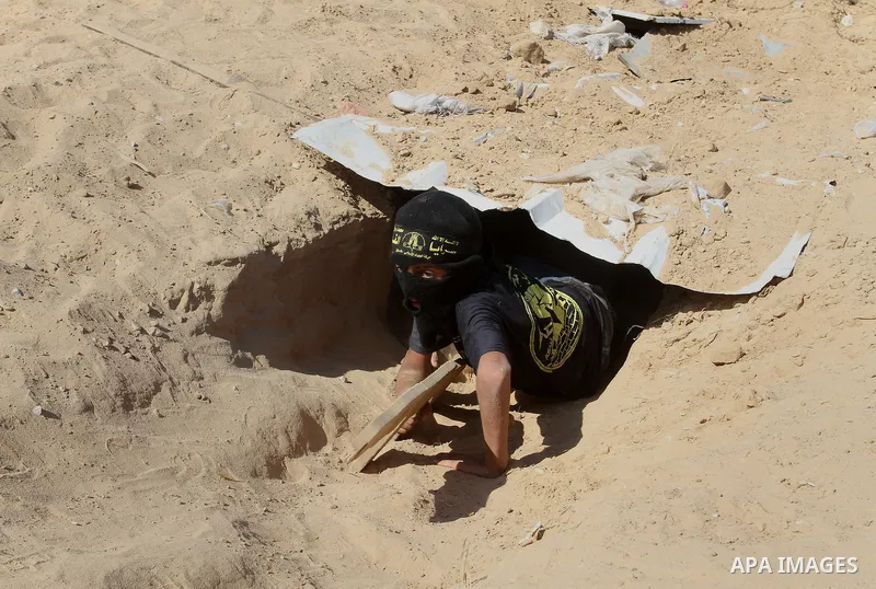 Young Palestinians take part in a military-style exercise at a summer camp organised by the Islamic Jihad movement in Khan Yunis in the southern Gaza Strip, during the youngsters' summer school vacation, on July 14, 2016...