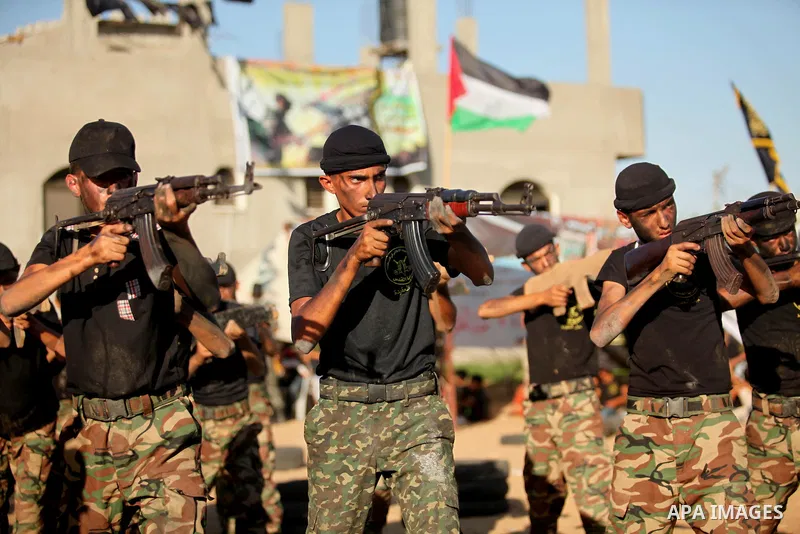 Palestinian youths take part in a military-style graduation ceremony at a summer camp organized by the Islamic Jihad Movement in Khan Younis in the southern Gaza Strip July 15, 2016. Photo by Ashraf Amra