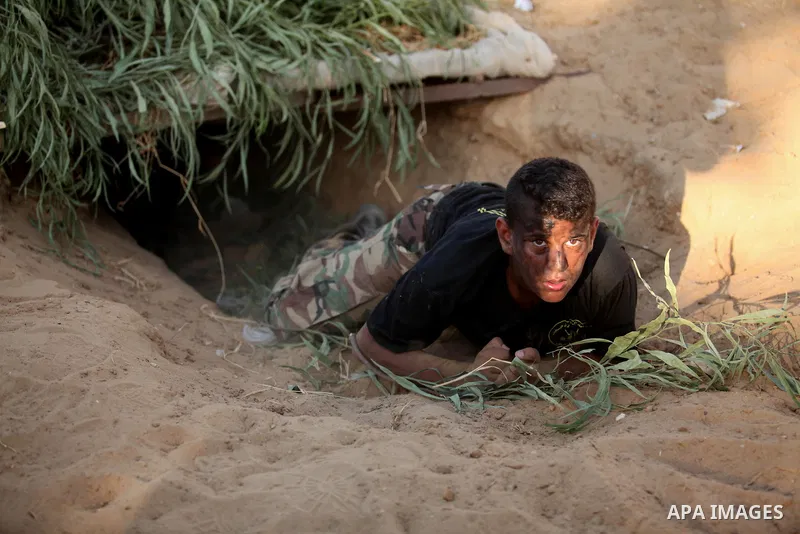 Palestinian youths take part in a military-style graduation ceremony at a summer camp organized by the Islamic Jihad Movement in Khan Younis in the southern Gaza Strip July 15, 2016. Photo by Ashraf Amra
