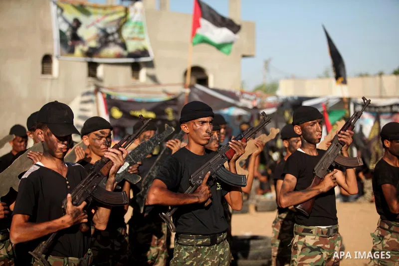 Palestinian youths take part in a military-style graduation ceremony at a summer camp organized by the Islamic Jihad Movement in Khan Younis in the southern Gaza Strip July 15, 2016. Photo by Ashraf Amra