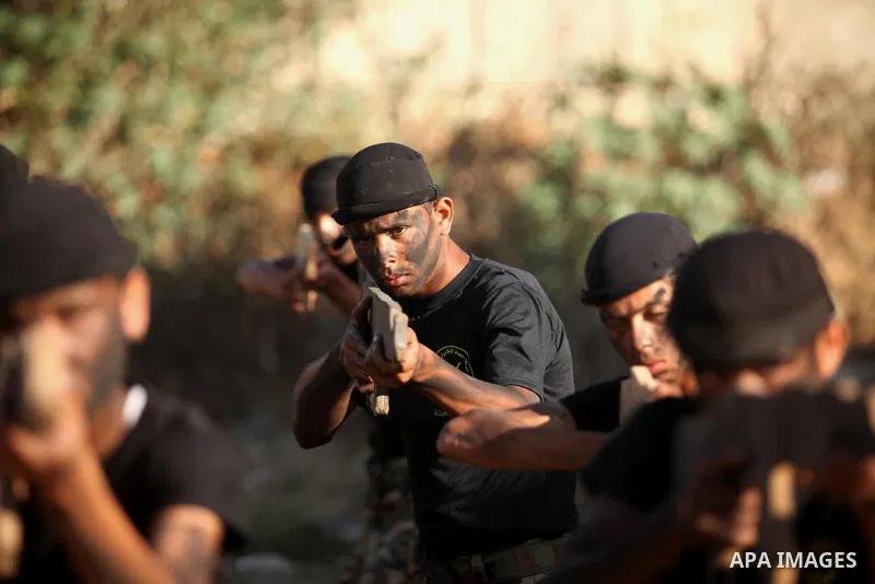 Palestinian youths take part in a military-style graduation ceremony at a summer camp organized by the Islamic Jihad Movement in Khan Younis in the southern Gaza Strip July 15, 2016. Photo by Ashraf Amra