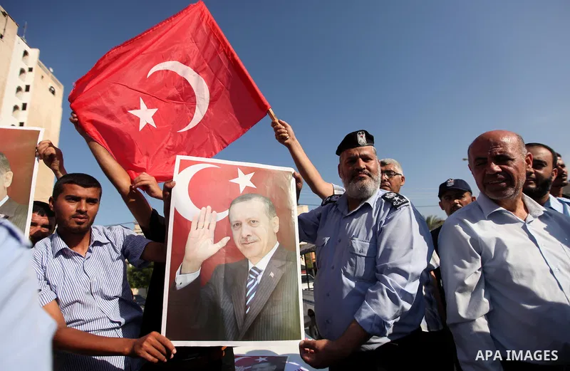 Palestinians hold banners during a protest against military coup attempt in Turkey, in Khan Younis in the southern Gaza strip, on July 16, 2016. President Recep Tayyip Erdogan battled to regain control over Turkey on Jul...